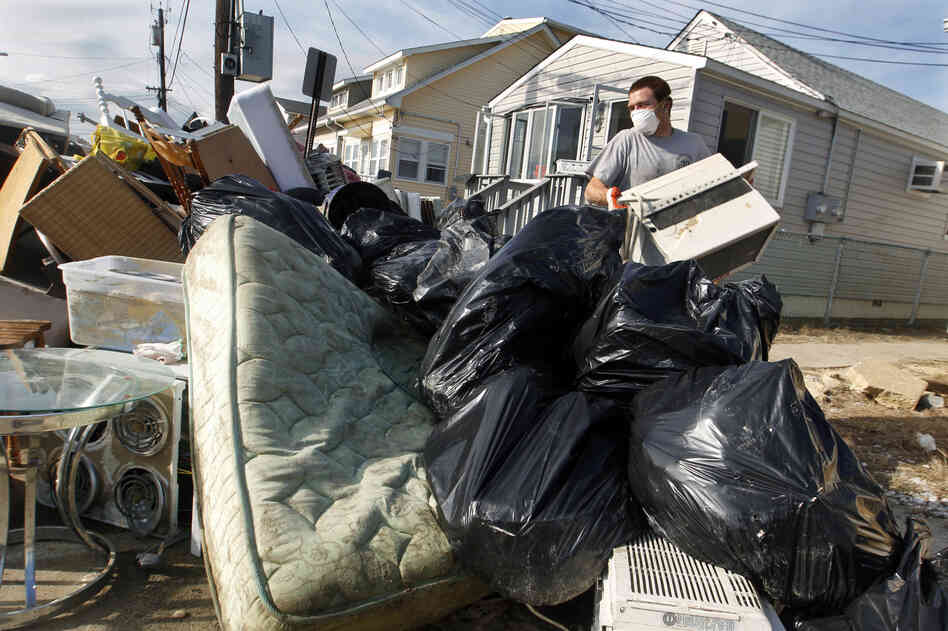 Ernest Shallo, of Carteret, N.J., throws a ruined air conditioner onto a pile of debris in front of a small home in Seaside Heights, N.J. Residents were allowed back in their homes for a few hours Monday, two weeks after the region was pounded by Superstorm Sandy. Ernest Shallo, of Carteret, N.J., throws a ruined air conditioner onto a pile of debris in front of a small home in Seaside Heights, N.J. Residents were allowed back in their homes for a few hours Monday, two weeks after the region was pounded by Superstorm Sandy.