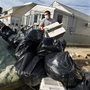 Ernest Shallo, of Carteret, N.J., throws a ruined air conditioner onto a pile of debris in front of a small home in Seaside Heights, N.J. Residents were allowed back in their homes for a few hours Monday, two weeks after the region was pounded by Superstorm Sandy. Ernest Shallo, of Carteret, N.J., throws a ruined air conditioner onto a pile of debris in front of a small home in Seaside Heights, N.J. Residents were allowed back in their homes for a few hours Monday, two weeks after the region was pounded by Superstorm Sandy.
