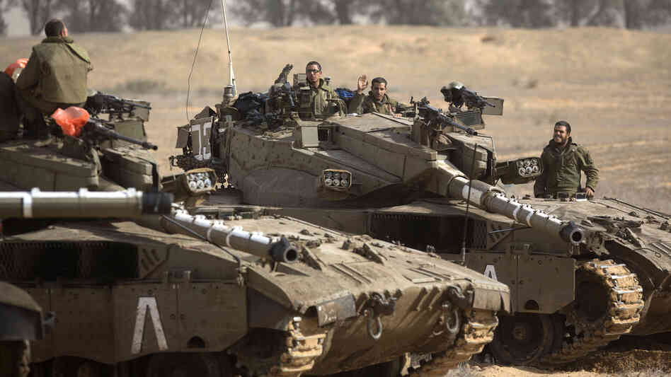 Israeli tanks on the border with the Gaza Strip earlier today. Israeli officials have said they are prepared to mount a ground offensive.