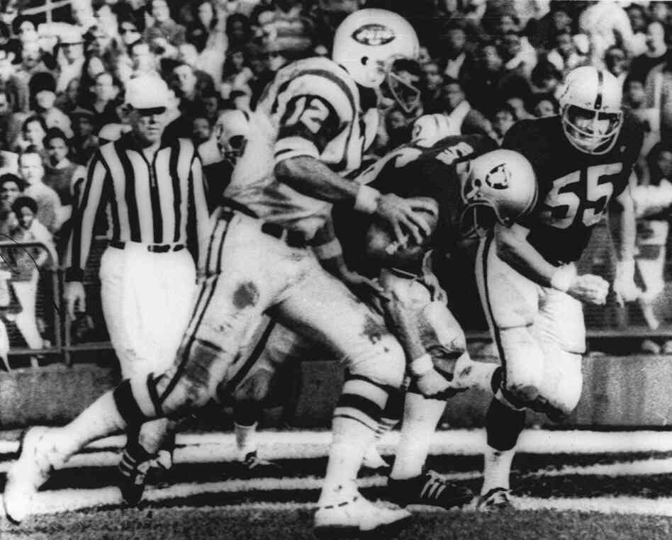 "The Heidi Game": New York Jets quarterback Joe Namath sweeps around the right side past Oakland defenders Ralph Oliver and Dan Conners to score from the one-yard line during the second quarter against the Oakland Raiders in Oakland on Nov. 17, 1968.