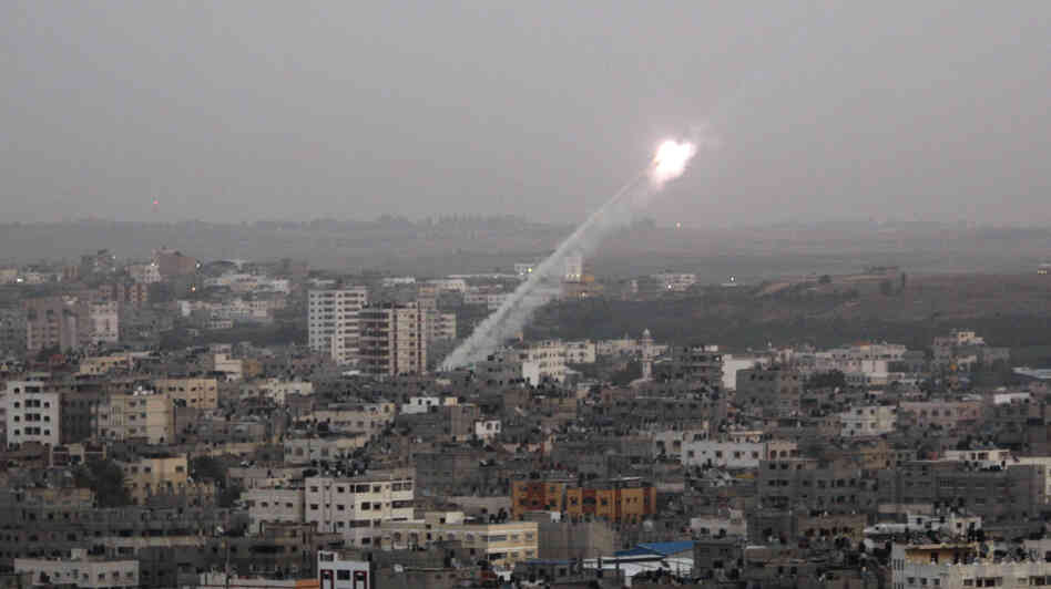 Rockets lunched by Palestinian militants toward Israel make their way from the northern Gaza Strip on Saturday.