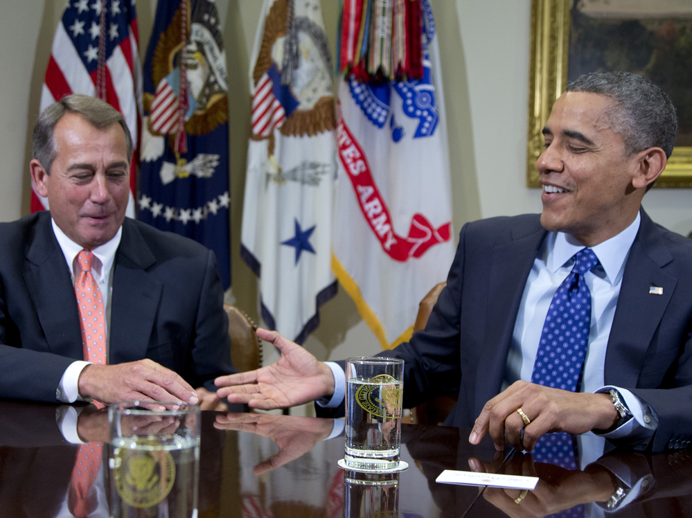 President Obama reaches to shake hands with House Speaker John Boehner in the White House Friday, during a meeting to discuss the deficit and economy.