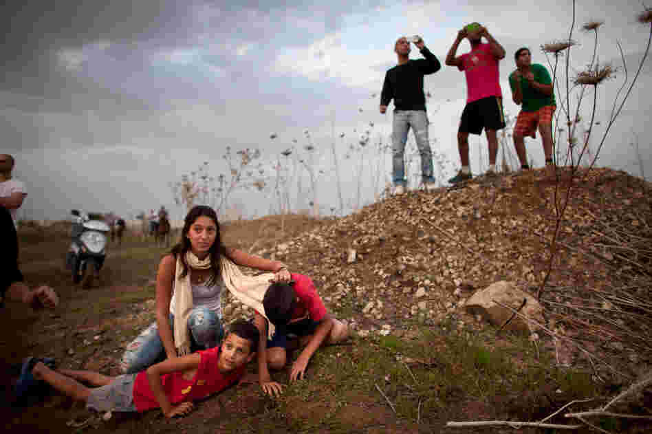 Israeli civilians in Tel Aviv run for cover during a rocket attack launched from Gaza on Saturday.