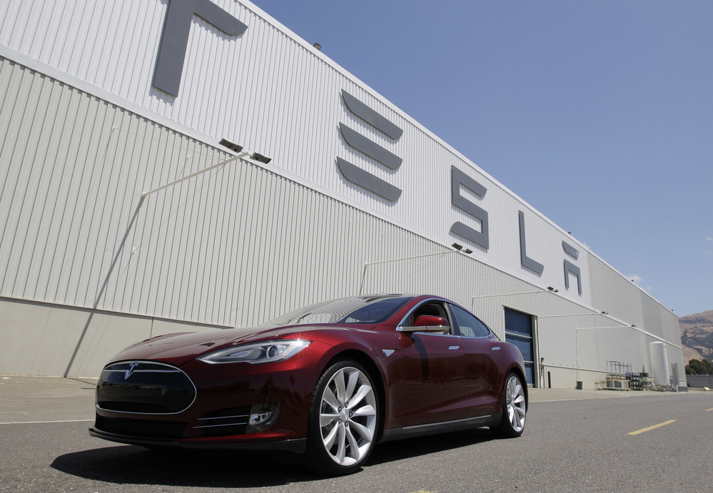 A Tesla Model S drives outside the Tesla factory in Fremont, Calif., Friday, June 22, 2012. The electric car was recently named Automobile of the Year by Automobile magazine and Car of the Year by Motor Trend.