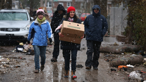Volunteers walk through a snowstorm while bringing of food to residents of homes damaged by Superstorm Sandy on Nov. 7 in the Staten Island borough of New York City. Volunteers walk through a snowstorm while bringing of food to residents of homes damaged by Superstorm Sandy on Nov. 7 in the Staten Island borough of New York City.