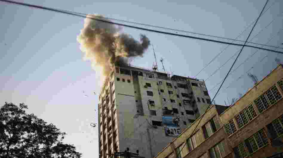 Smoke billows from the local Al-Aqsa TV station in Gaza City Sunday after an Israeli airstrike.