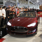 Tesla workers cheer on the first Tesla Model S cars sold during a rally at the Tesla factory in Fremont, Calif., in June.