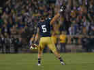 Manti T'eo #5 of the Notre Dame Fighting Irish waves to the crowd as he leaves the home field for the last time after a 38-0 win against the Wake Forest Demon Deacons.