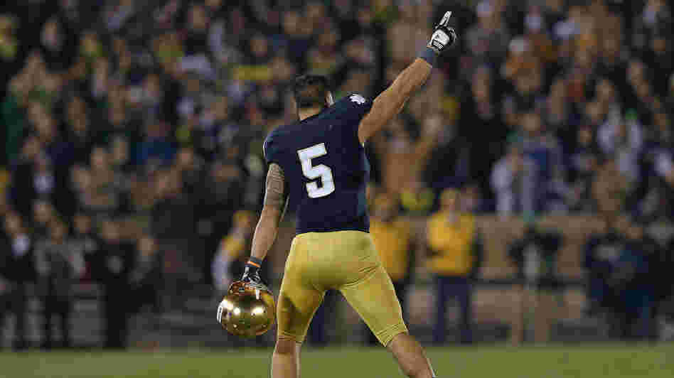 Manti T'eo #5 of the Notre Dame Fighting Irish waves to the crowd as he leaves the home field for the last time after a 38-0 win against the Wake Forest Demon Deacons.