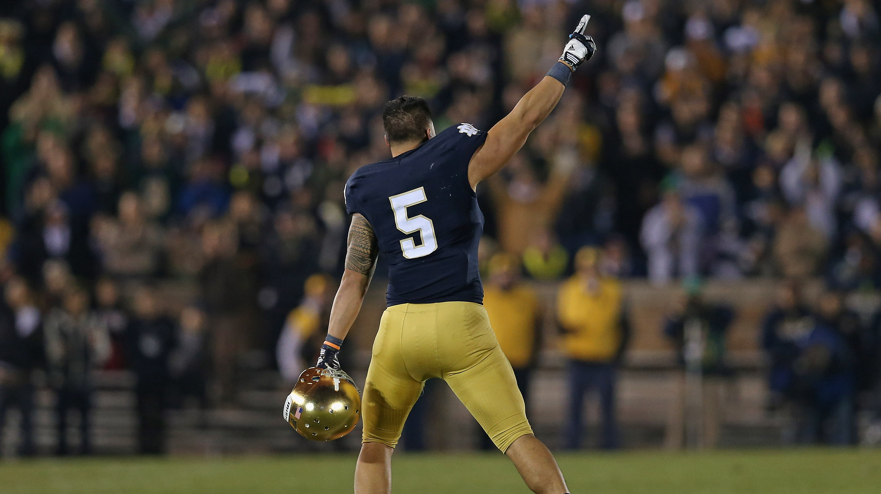 Manti T'eo #5 of the Notre Dame Fighting Irish waves to the crowd as he leaves the home field for the last time after a 38-0 win against the Wake Forest Demon Deacons.