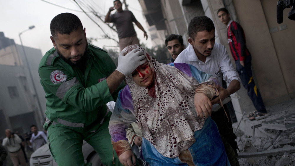 The Israelis and Palestinians have clashed repeatedly over the Gaza Strip, but the recent upheavals in the Middle East have changed the dynamics this time. Here, a Palestinian woman is helped after being injured in an Israeli strike in Gaza City on Monday.
