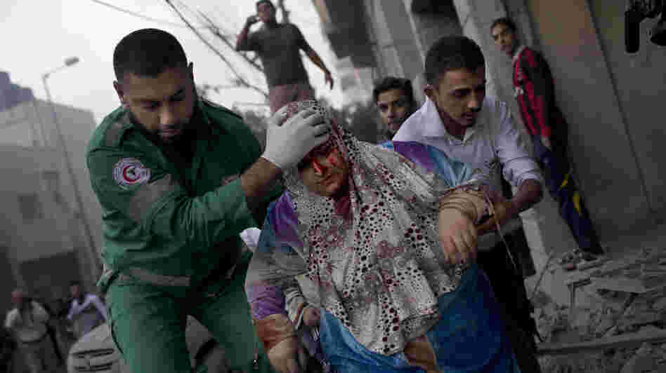 The Israelis and Palestinians have clashed repeatedly over the Gaza Strip, but the recent upheavals in the Middle East have changed the dynamics this time. Here, a Palestinian woman is helped after being injured in an Israeli strike in Gaza City on Monday.