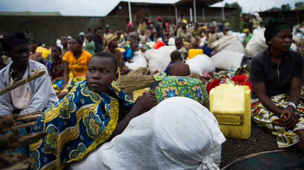 Fleeing the fighting: Internally displaced Congolese sit inside a United Nations base in Monigi, near Goma, as they seek shelter from the violence.