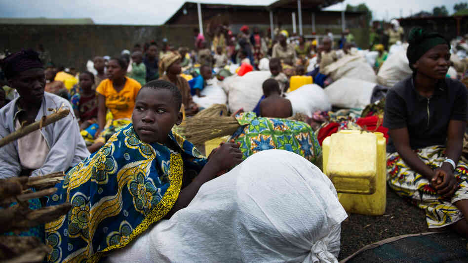 Fleeing the fighting: Internally displaced Congolese sit inside a United Nations base in Monigi, near Goma, as they seek shelter from the violence.