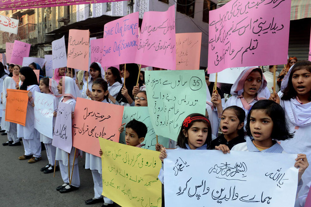 Students demand the reopening of the Farooqi Girls High School in Lahore, Pakistan, in early November. A mob attacked the school in October, accusing a teacher of insulting the Prophet Muhammad. It takes just one accusation to lead to an arrest under Pakistan's stringent blasphemy laws.