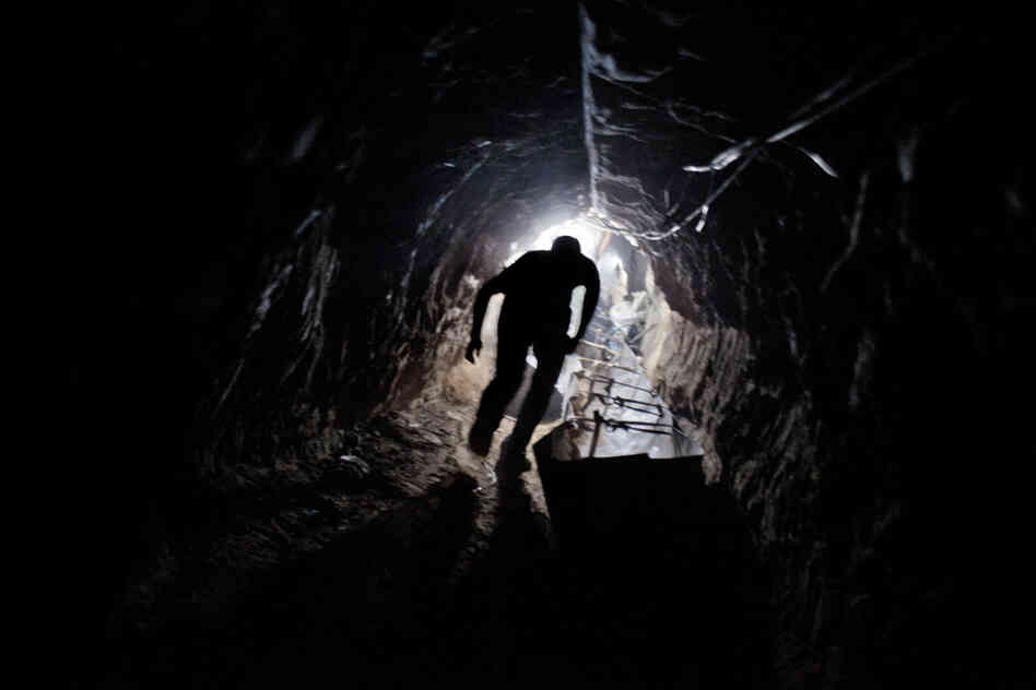 A worker emerges from one of hundreds of smuggling tunnels that connect the Gaza Strip and Egypt.