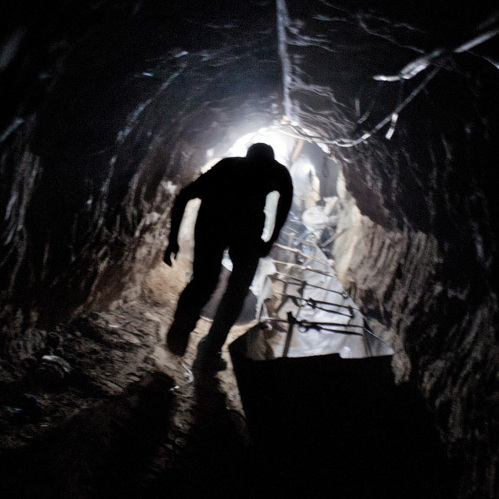 A worker emerges from one of hundreds of smuggling tunnels that connect the Gaza Strip and Egypt.