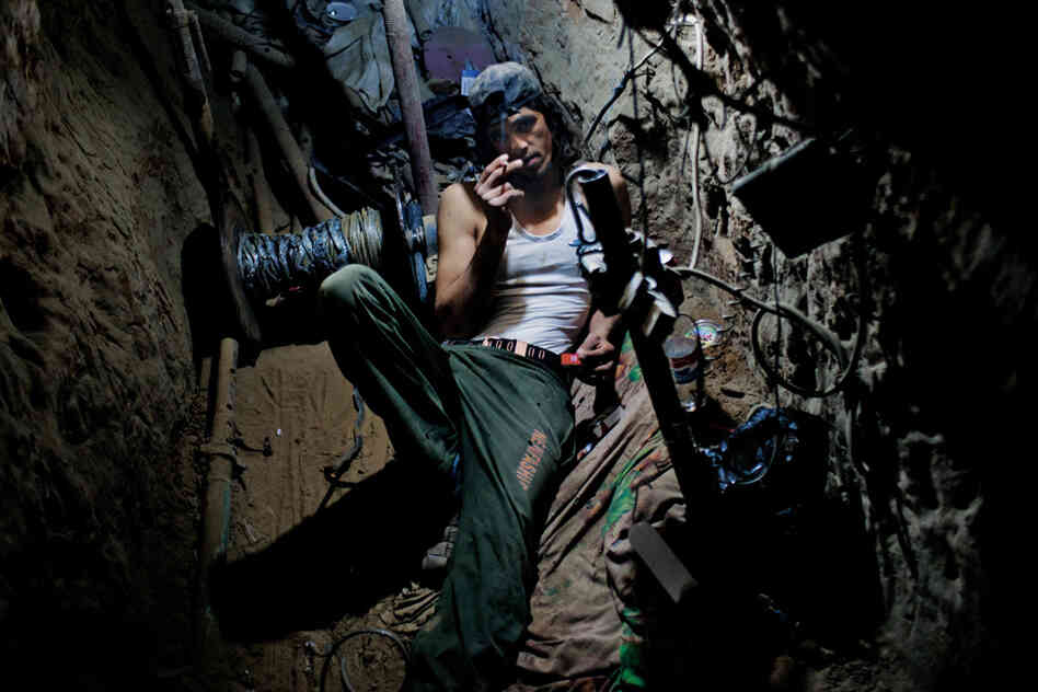 This Gazan university student works in a tunnel, hauling goods to earn money for tuition. Many workers put in 12-hour shifts six days a week — or more — in the cramped spaces. Gas explosions, electrocutions and Israeli airstrikes are common.