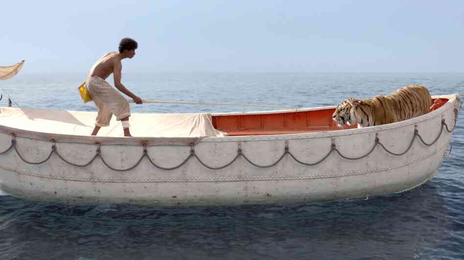 Pi Patel (Suraj Sharma) is lost at sea with a fierce Bengal tiger, Richard Parker. Pi Patel (Suraj Sharma) is lost at sea with a fierce Bengal tiger, Richard Parker.