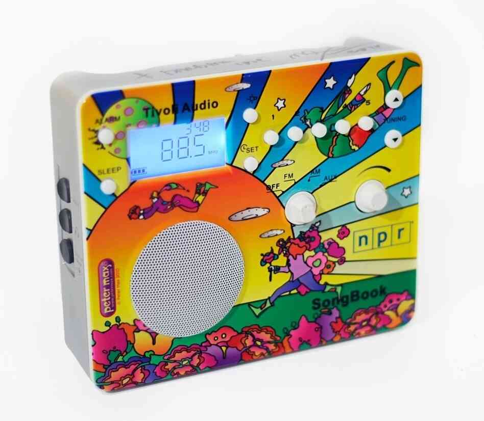 The Tivoli AM/FM Songbook: designed by iconic pop artist Peter Max, is already a work of art with its high-fidelity sound, sensitive digital tuner, alarm clock, sleep timer, and built-in charger for NiMH/NiCAD batteries. The Tivoli AM/FM Songbook: designed by iconic pop artist Peter Max, is already a work of art with its high-fidelity sound, sensitive digital tuner, alarm clock, sleep timer, and built-in charger for NiMH/NiCAD batteries.