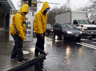 Parking attendants search for a clogged drain in Seattle Monday. Pacific storms are rolling across the Northwest, according to the National Weather Service. Parking attendants search for a clogged drain in Seattle Monday. Pacific storms are rolling across the Northwest, according to the National Weather Service.