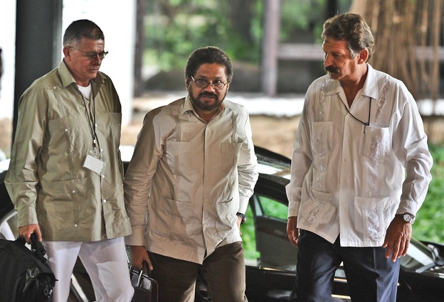 Colombian members of FARC, commanders Ivan Marquez, center, and Rodrigo Granda, left, arrive at Convention Palace in Havana for the peace talks with the Colombian government on Monday.