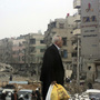 A man walks near buildings damaged after shelling by forces loyal to Syria's President Bashar Assad, at Harasta, a suburb of Damascus, on Nov. 19.