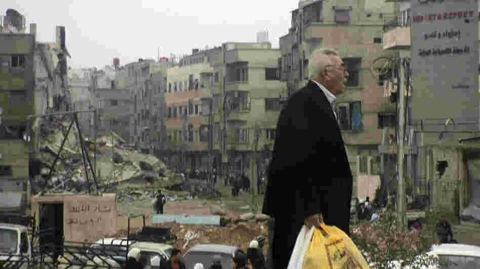 A man walks near buildings damaged after shelling by forces loyal to Syria's President Bashar Assad, at Harasta, a suburb of Damascus, on Nov. 19.