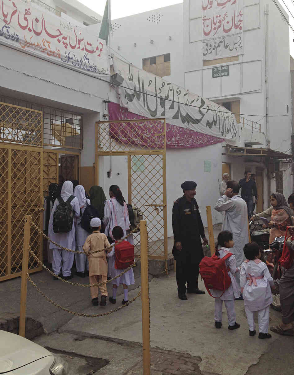 Students file into Lahore's reopened Farooqi Girls High School. The school was temporarily closed after a violent attack in October.