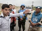Supporters of President Bashar Assad speak with U.N. monitors who were arriving in the town in May. The monitors have since left. Supporters of President Bashar Assad speak with U.N. monitors who were arriving in the town in May. The monitors have since left.