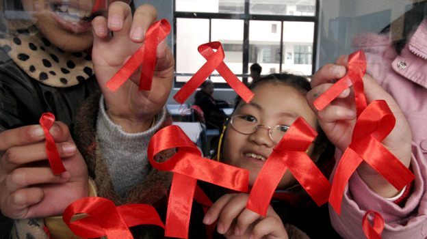 Students paste red ribbons on a window to mark World AIDS Day in Nanjing, China, in 2006. Between 2007 and 2011, the number of newly diagnosed HIV cases in China has nearly quadrupled to 40,000.