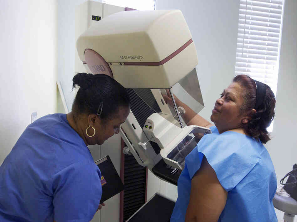 A mammographer prepares a screen-film mammography test for patient Alicia Maldonado at a hospital in Los Angeles.