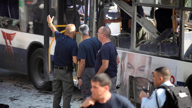 Israeli police and rescue personnel at the scene of the bus bombing in central Tel Aviv today.