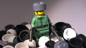 This figure is wearing the BrickArms Ushanka (Russian hat), and holding the BrickArms TT-33 pistol and PPSh submachine gun. The uniform is a Lego design from the Indiana Jones Lego series.
