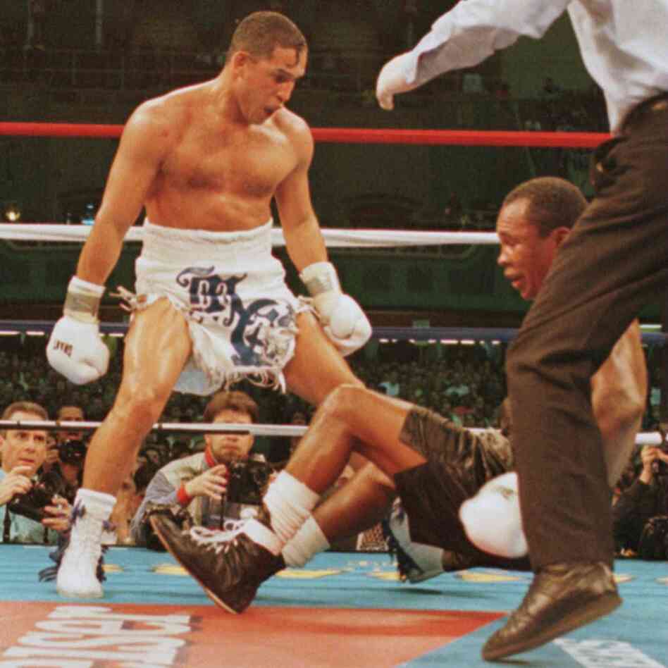 March 1, 1997: Hector "Macho" Camacho watches as "Sugar" Ray Leonard falls to the canvas during action in the fifth round of their fight.