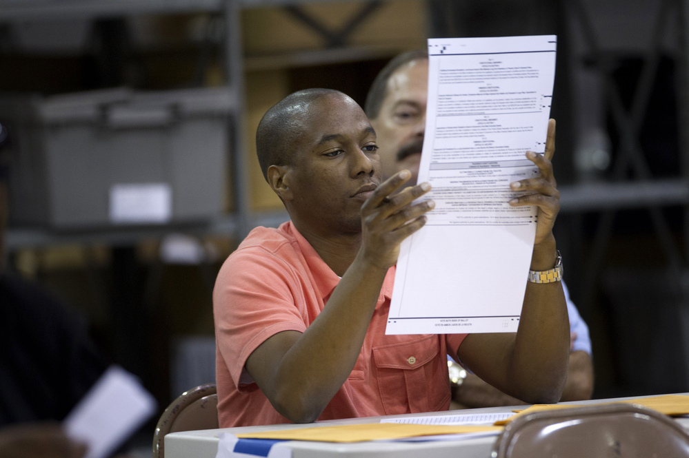 A Palm Beach County election worker counts ballots in Riviera Beach, Fla., on Nov. 9. Rep. Allen West contested the results of the election in Florida's 18th District for two weeks before conceding. Since 2000, the number of contested elections has more than doubled.