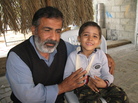 Osama Qurtom and his son Mahmoud at their home in Gaza. Osama Qurtom and his son Mahmoud at their home in Gaza.