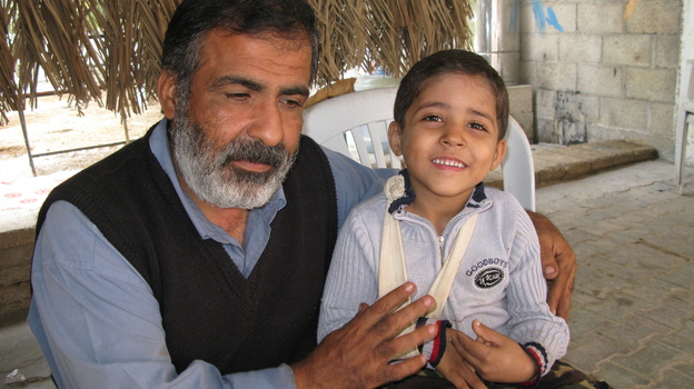 Osama Qurtom and his son Mahmoud at their home in Gaza. (NPR)