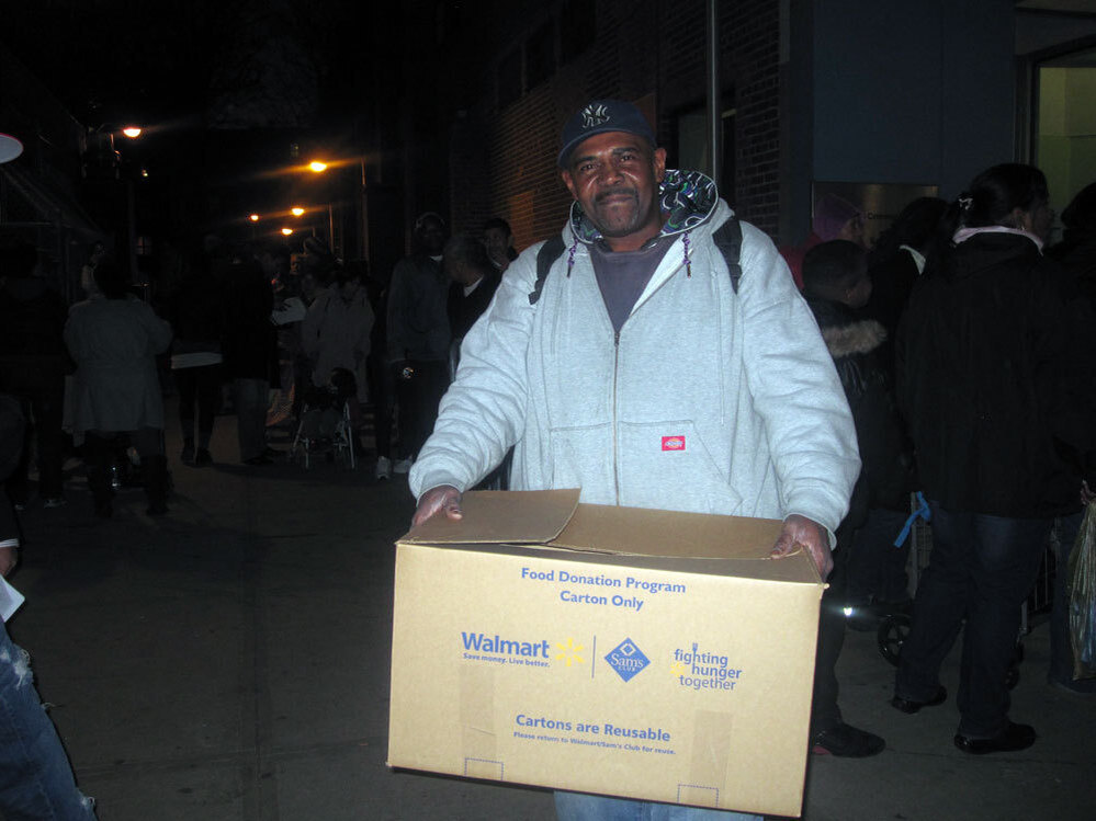 Maurice Geddie of Brooklyn's Red Hook neighborhood picks up a free turkey donated by a local grocery store. He's hoping his wife will be willing to cook it, though she's been stuck cooking for storm victims at shelters for weeks.