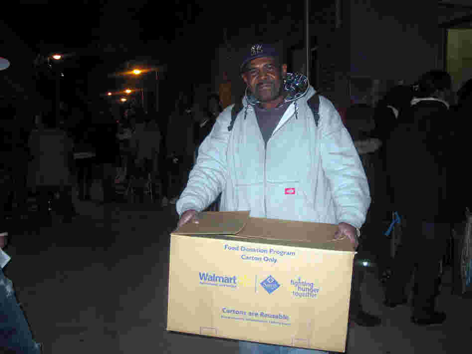 Maurice Geddie of Brooklyn's Red Hook neighborhood picks up a free turkey donated by a local grocery store. He's hoping his wife will be willing to cook it, though she's been stuck cooking for storm victims at shelters for weeks.