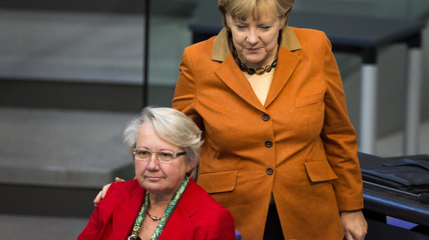 German Chancellor Angela Merkel (right) has given guarded support to Education Minister Annette Schavan, who is facing calls to resign over allegations of plagiarism.