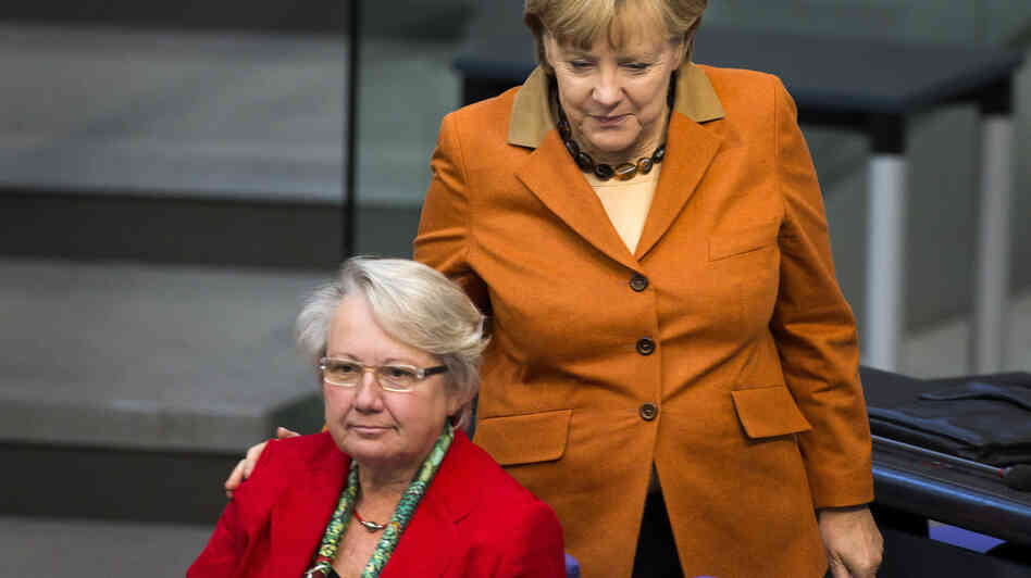 German Chancellor Angela Merkel (right) has given guarded support to Education Minister Annette Schavan, who is facing calls to resign over allegations of plagiarism.
