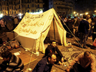 Pro-democracy demonstrators occupy Cairo's Tahrir Square on Friday night. The writing on the tent reads, "Egypt is not a farm, Constitution party, Egypt for Egyptians." Pro-democracy demonstrators occupy Cairo's Tahrir Square on Friday night. The writing on the tent reads, "Egypt is not a farm, Constitution party, Egypt for Egyptians."