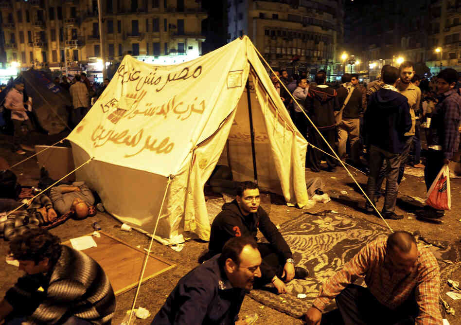 Pro-democracy demonstrators occupy Cairo's Tahrir Square on Friday night. The writing on the tent reads, "Egypt is not a farm, Constitution party, Egypt for Egyptians."