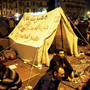 Pro-democracy demonstrators occupy Cairo's Tahrir Square on Friday night. The writing on the tent reads, "Egypt is not a farm, Constitution party, Egypt for Egyptians." Pro-democracy demonstrators occupy Cairo's Tahrir Square on Friday night. The writing on the tent reads, "Egypt is not a farm, Constitution party, Egypt for Egyptians."