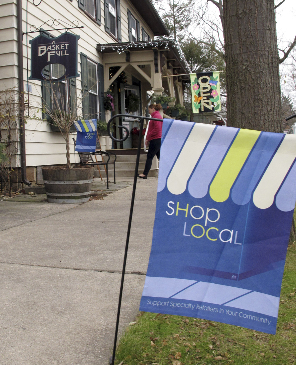 A flag urges customers to shop locally near a store in Boalsburg, Pa., on Friday. Owners of small stores hope to get a boost from Small Business Saturday.
