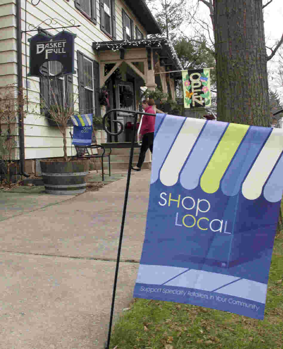 A flag urges customers to shop locally near a store in Boalsburg, Pa., on Friday. Owners of small stores hope to get a boost from Small Business Saturday.