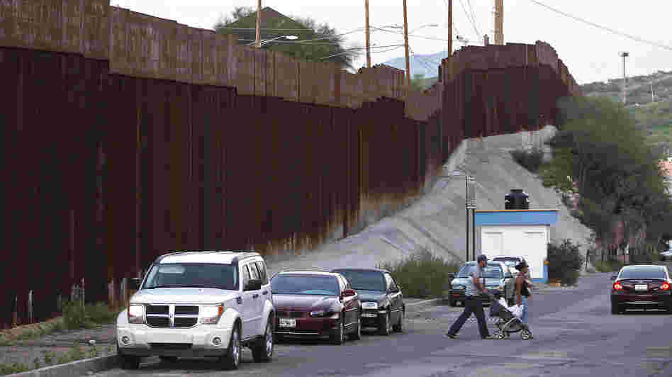 Pedestrians cross the street in Nogales, Mexico, near the border with Arizona. A U.S. Border Patrol agent shot and killed a 16-year-old boy who was throwing rocks near the border fence last month.