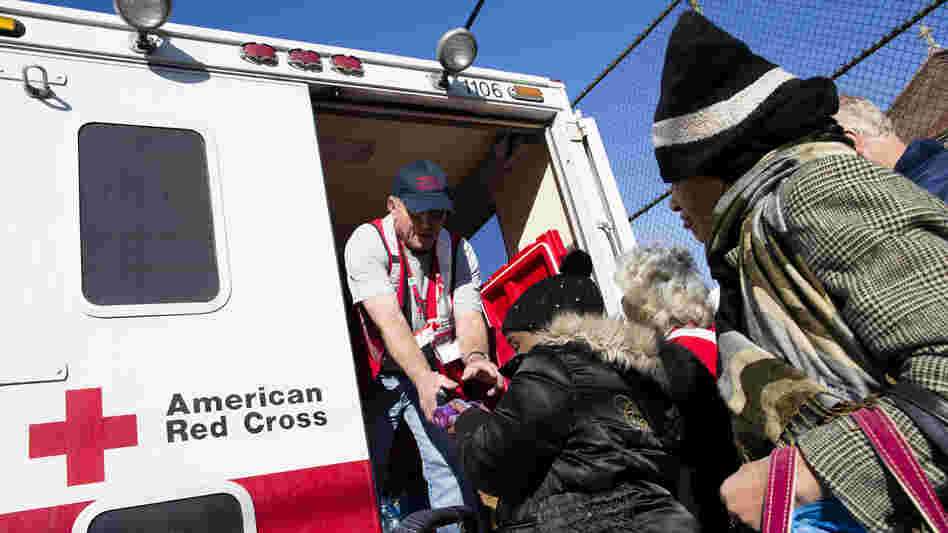 A member of the Red Cross distributes food to residents of Coney Island affected by Superstorm Sandy in the Brooklyn, N.Y., on Nov. 9.