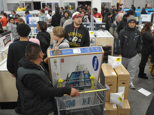 Shoppers line up in a Best Buy store in Rockville, Md., during a Black Friday sale. Thanksgiving weekend sales jumped nearly 13 percent from last year, the National Retail Federation says.